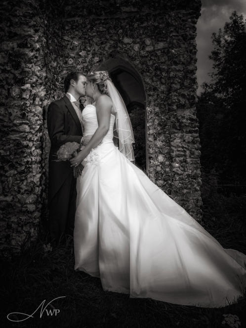 Bride and groom kissing at Donnington Grove Hotel by Newbury Wedding Photography
