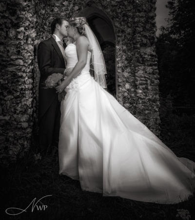 Bride and groom kissing at Donnington Grove Hotel by Newbury Wedding Photography